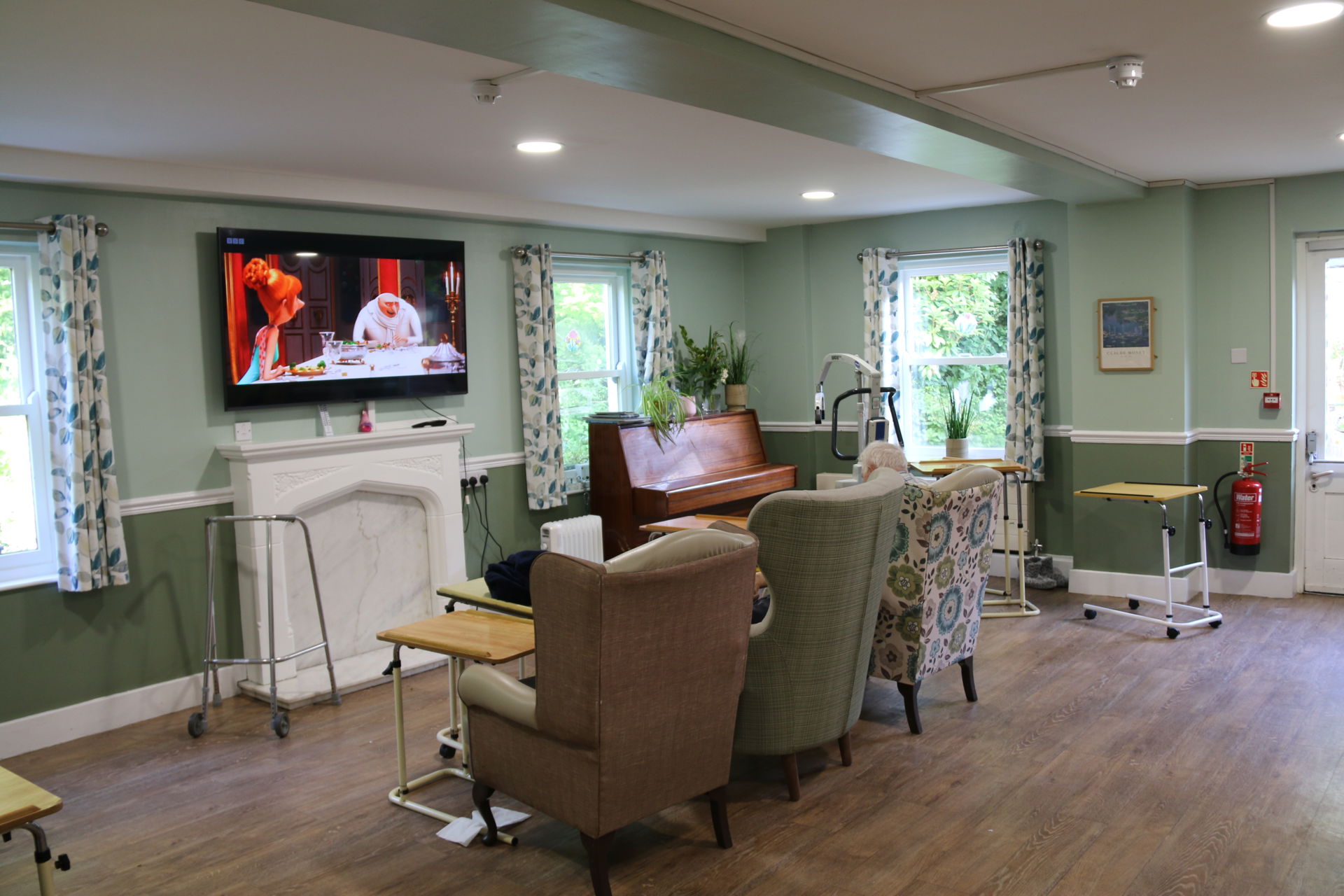 A bright, homely communal lounge at Rickeston Mill