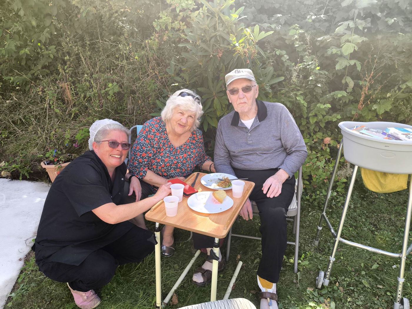 A Rickeston Mill carer spending time with residents in the garden