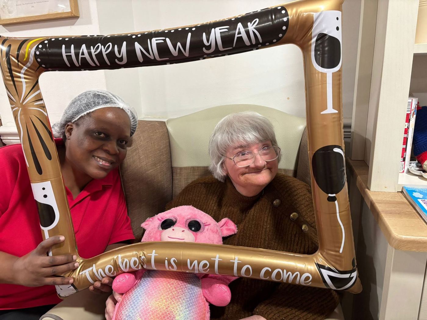 A carer sharing a happy moment with a resident at Rickeston Mill